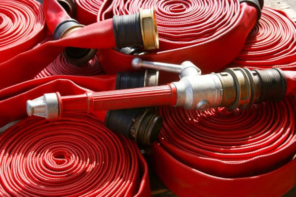 Coiled fire hoses with nozzle