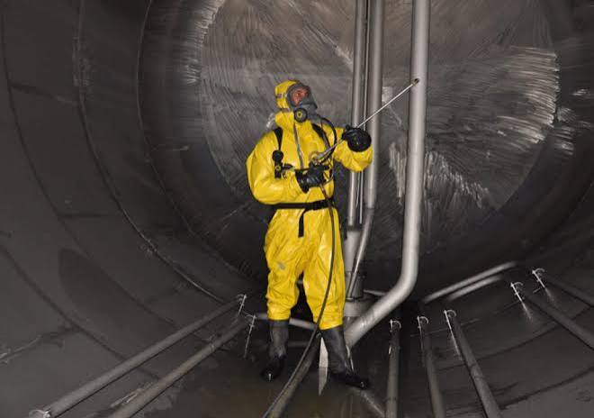 Tank cleaning chemical application by technician